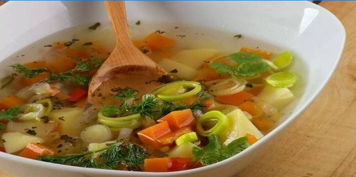 Sopa de verduras con aguacate en un plato