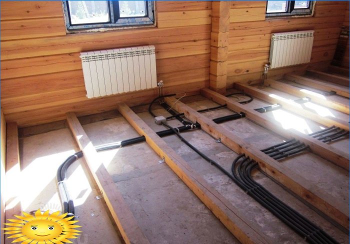 Tuberías de calefacción en una casa de troncos debajo del piso