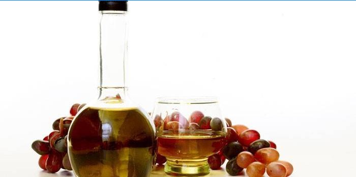 Vinagre de vino en una jarra y uvas